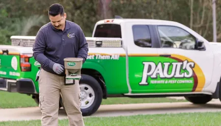 technician working on lawn, seeding and fertilizing lawn